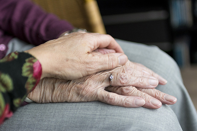 zwei übereinanderliegende Hände von älteren Frauen