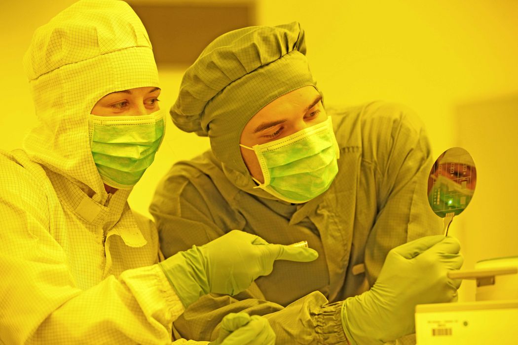 two scientist in the laboratory study a wafer