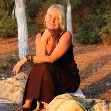Frau Kerstin Bucher sitzt auf einem Stein