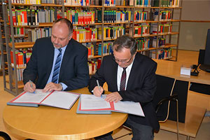 Andreas Fleischer und Prof. Gunter Krautheim unterzeichnen den Kooperationsvertrag.