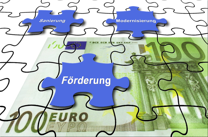 Illustration. Ein 100 Euro Schein als Puzzle dargestellt. In einem Puzzlestein steht Förderung. 