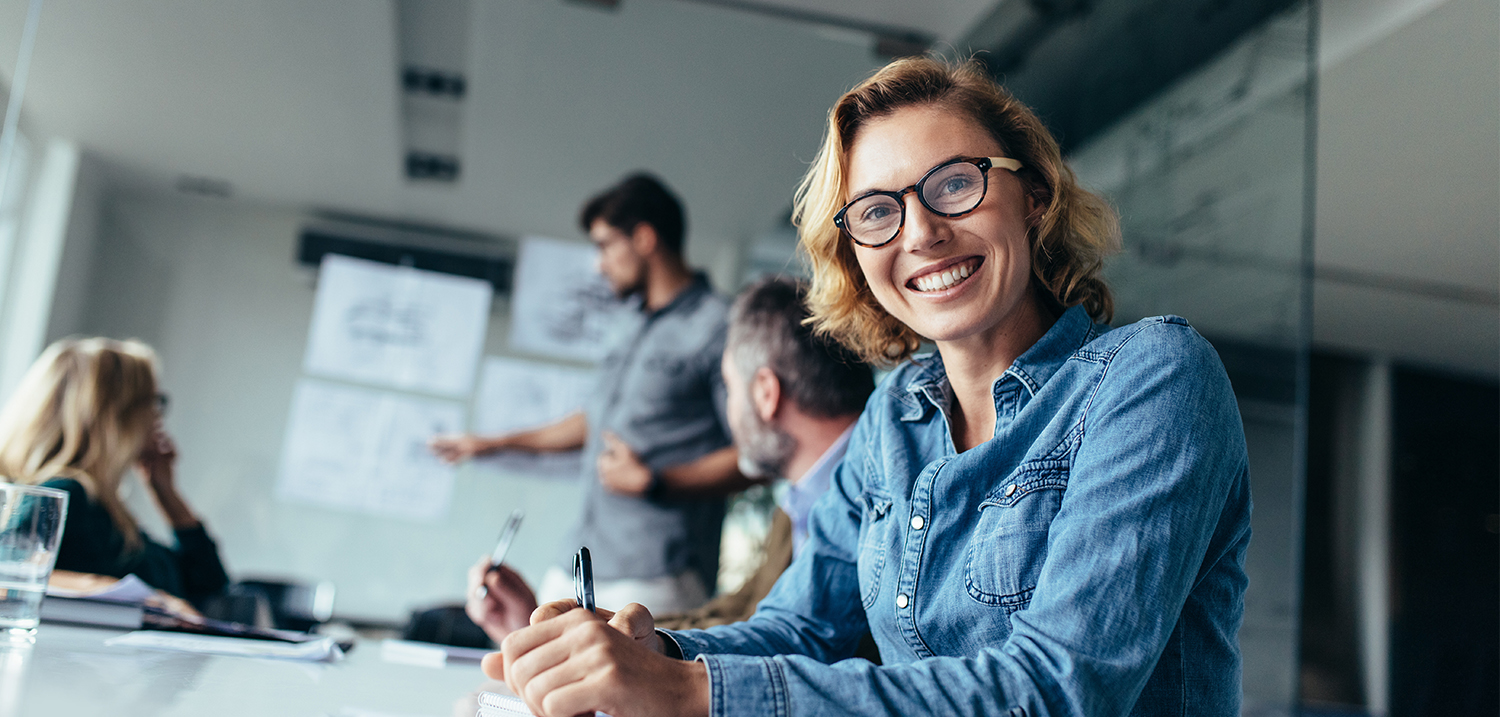 Woman sitting in board room during business meeting. 